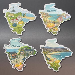 May include: Four Devon-shaped magnets with illustrated scenes. Each magnet features a different coastal landscape with the word "Devon" at the top. The illustrations include beaches, buildings, food, and a lighthouse.