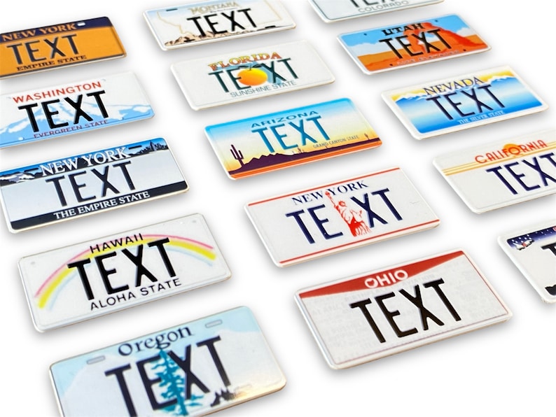 May include: A collection of 14 miniature license plates from different states in the U.S. Each plate features the state name and the word "TEXT" in black lettering. The plates are arranged in a staggered pattern on a white surface.