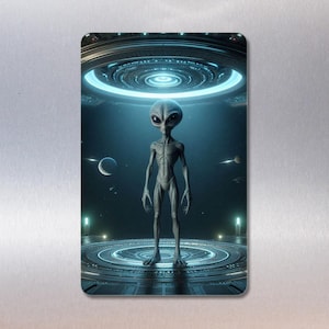 May include: A grey alien stands on a circular platform with a glowing ring above it. The alien has large eyes and a small mouth. The platform is surrounded by a dark blue background with stars.
