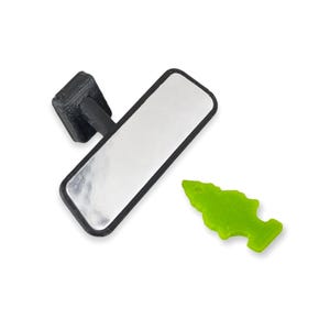 May include: A black rearview mirror with a rectangular reflective surface and a black frame. A small, bright green fish-shaped object is next to the mirror. The objects are on a white background.