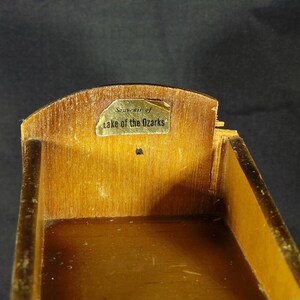 May include: A wooden box with a gold label that reads "Souvenir of Lake of the Ozarks".