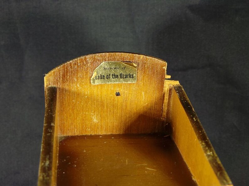 May include: A wooden box with a gold label that reads "Souvenir of Lake of the Ozarks".