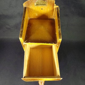 May include: A small wooden box with a drawer. The box has a label that says "Souvenir of Lake of the Ozarks".
