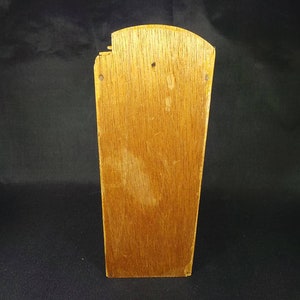 May include: A wooden box with a slightly rounded top. The box is made of light brown wood and has a natural finish. The box is empty and has no visible markings or decorations.