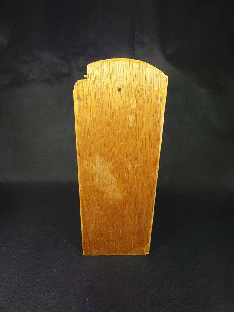 May include: A wooden box with a slightly rounded top. The box is made of light brown wood and has a natural finish. The box is empty and has no visible markings or decorations.