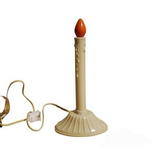 Può includere: Una candela elettrica bianca con un design a cera che cola e una lampadina arancione. La candela ha una base bianca con un design a coste e un cavo.