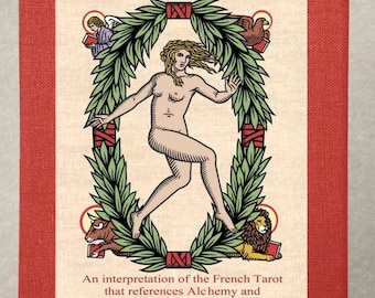 May include: A red and cream-colored tarot card box titled "The Alchemical Tarot of Marseille." The cover features a nude figure within a green wreath, with text below reading "An interpretation of the French Tarot..." by Robert M. Place.