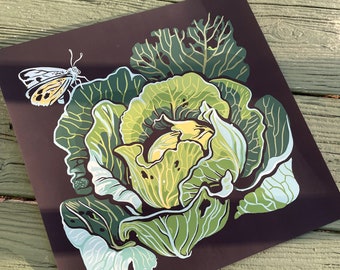 May include: A square print featuring a stylized illustration of a cabbage with a butterfly. The cabbage is depicted in shades of green and yellow against a dark brown background. A white and yellow butterfly is perched on the cabbage.