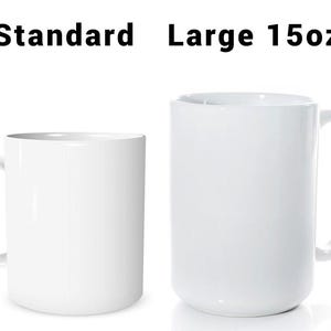 May include: Two white ceramic mugs, one standard size and one large 15oz. The mugs have a simple, clean design with a curved handle. The text "Standard" and "Large 15oz" is printed above the mugs.