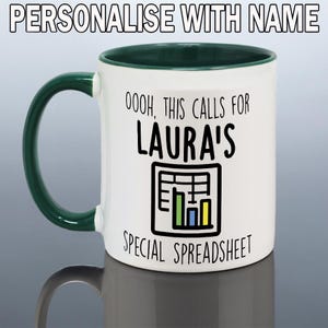 May include: White ceramic mug with a green handle and interior rim. The mug features the text "OOOH, THIS CALLS FOR LAURA'S SPECIAL SPREADSHEET" and a spreadsheet graphic. The top of the image reads "PERSONALIZE WITH NAME".