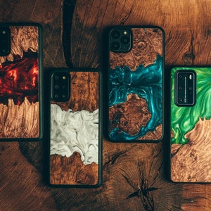 May include: Four different phone cases with a wood and resin design. The cases feature a variety of colors, including red, blue, green, and white.