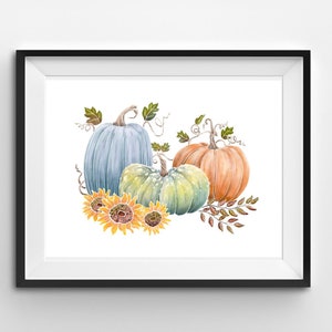Puede incluir: Una pintura de acuarela de tres calabazas con hojas de otoño y girasoles. Las calabazas son azules, verdes y naranjas.