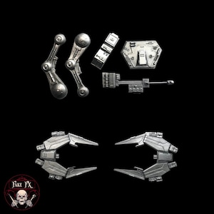 May include: A set of silver-colored plastic model pieces for a spaceship. The pieces include a cockpit, wings, and a gun turret.