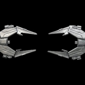 May include: Two silver-colored spaceship wings with detailed textures and sharp edges. The wings are angled upwards and outwards, creating a dynamic and futuristic look.
