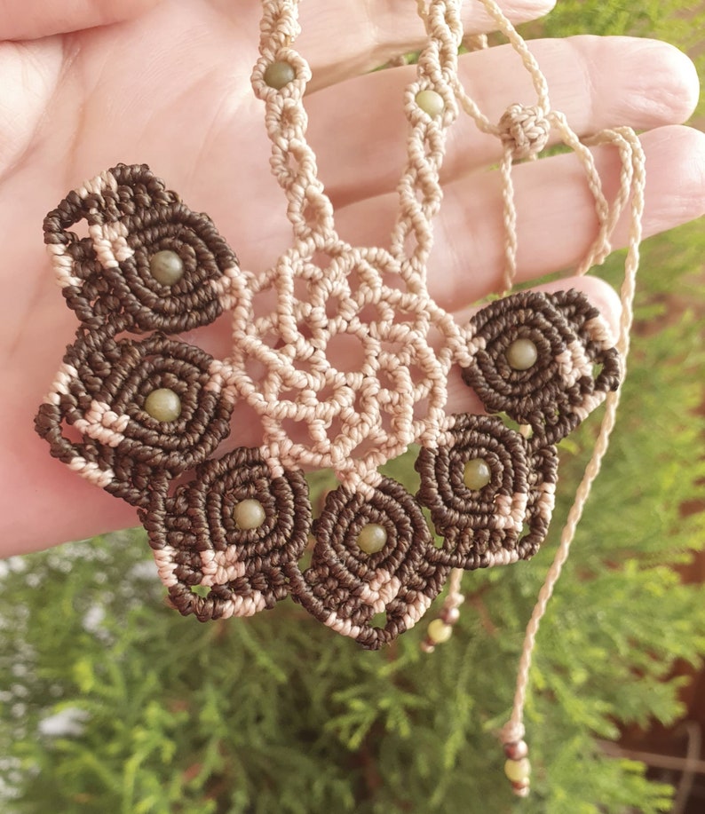 Macrame necklace in the shape of a floral half-mandala with jade beads