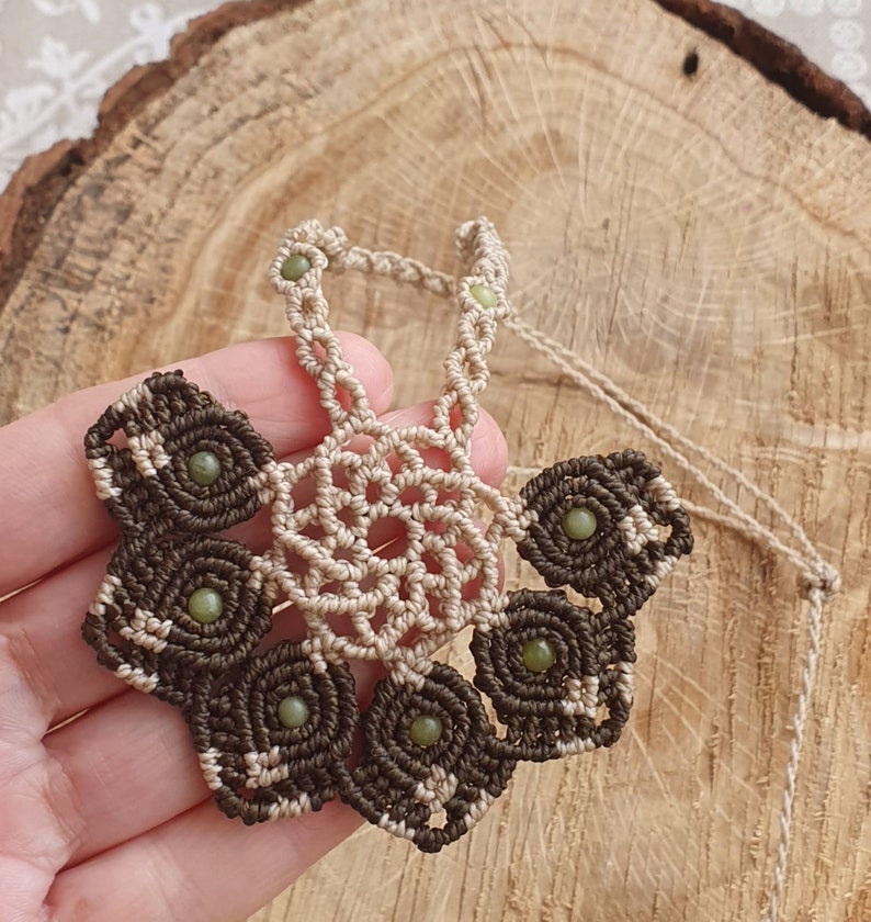 Macrame necklace in the shape of a floral half-mandala with jade beads