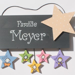 Türschild aus Holz für Familien mit Namen und Figuren auf Sternanhänger personalisiert. Holzschild mit Aufhängekordel. Familienschild für das Zuhause. Namensschild für die Haustür. Holztürschild handbemalt. Individuelles Einzugsgeschenk.