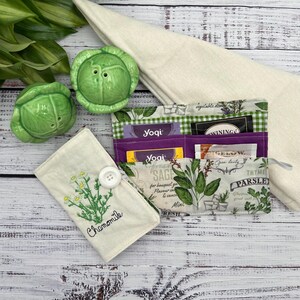 The dimensions of a tea wallet are 7 inches wide and 6 inches down. It has six pockets. The top pockets are longer than the short pockets on the front with the front pieces being 3 inches the second pockets 4 inches and the third pockets 5 inches.
