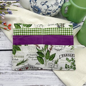 The packets are a green and white check which are 5 inches deep a purple, which is 4 inches deep and herb fabric that features different herbs that is 3 inches deep