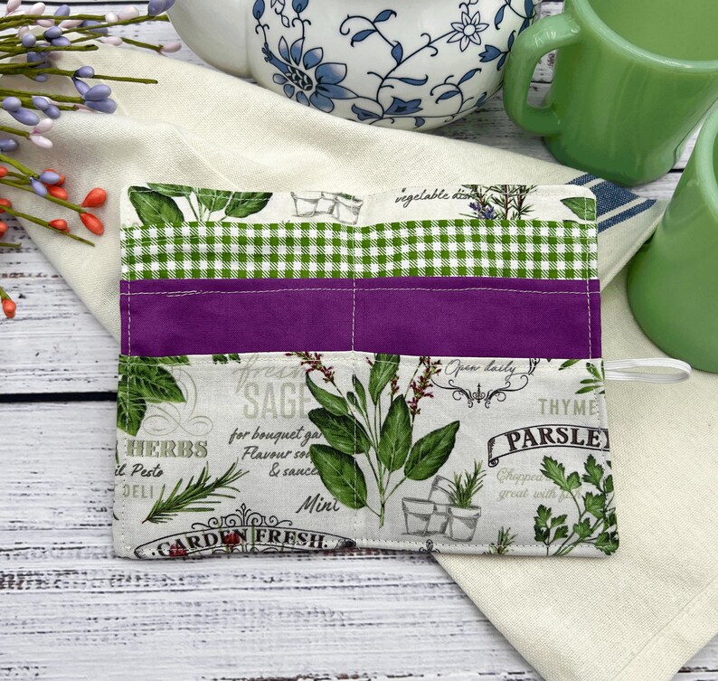 The packets are a green and white check which are 5 inches deep a purple, which is 4 inches deep and herb fabric that features different herbs that is 3 inches deep