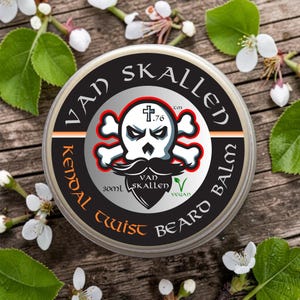 May include: A round container of beard balm with the text "VAD SKALLEN Twist BEARD BALM". The label features a skull and crossbones design with a mustache. The balm is vegan and contains 30ml.