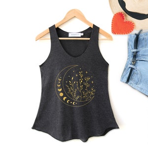 May include: A dark grey sleeveless top with a gold crescent moon and floral design. The top has a v-neck and the text "SIMPLY" is printed on the tag.