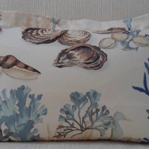 SEA SHELLS, SEAHORSE and ocean kelp in cream, blue, brown print.  Barbara Berry Collection for Kravet