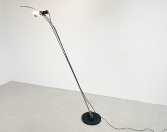 May include: A silver floor lamp with a curved arm and a black base. The lamp has a single light bulb.