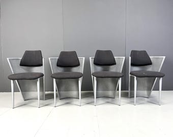 May include: Four black and white metal chairs with mesh backs and seats. The chairs are arranged in a row.