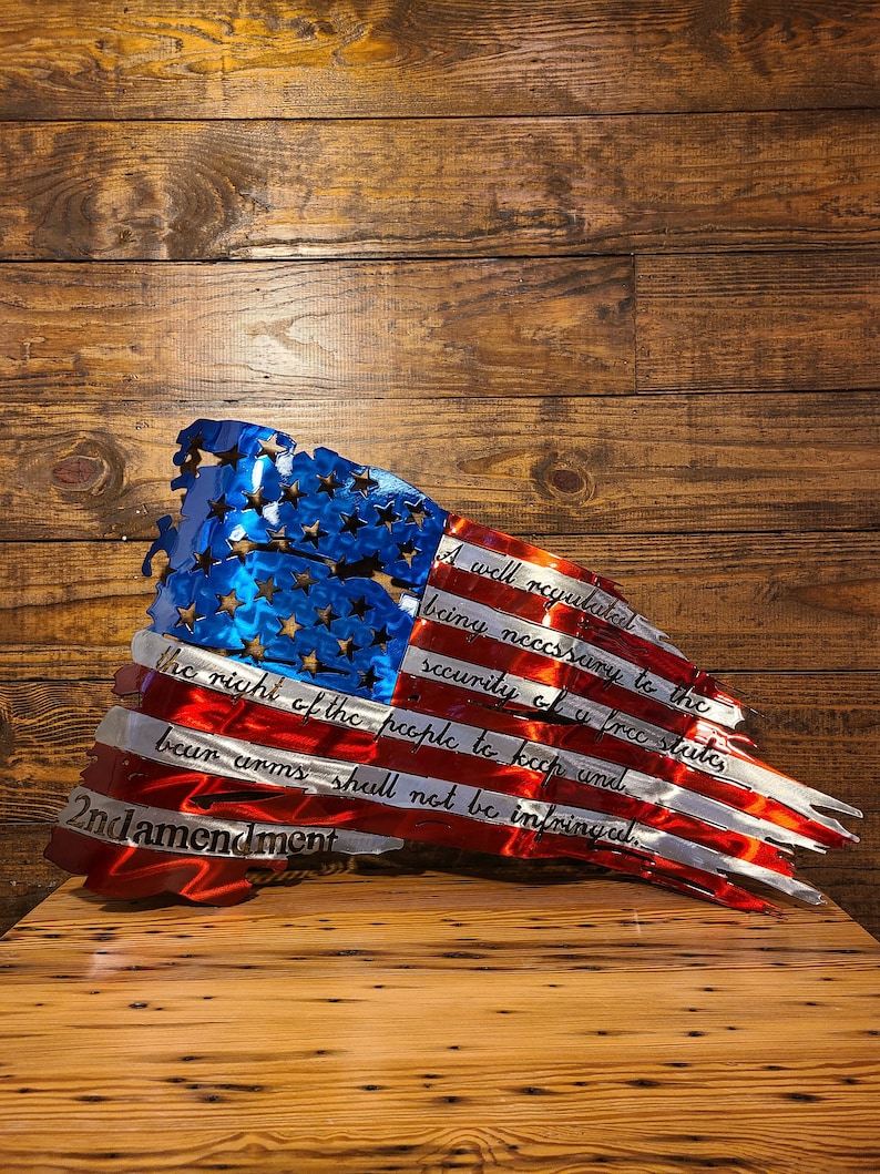 May include: A distressed metal American flag with the 2nd Amendment text: "A well regulated Militia, being necessary to the security of a free State, the right of the people to keep and bear Arms, shall not be infringed."