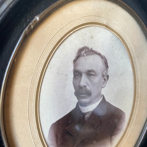 Antique 1882 Wooden Black Oval Picture Frame with portrait of shops a gentleman