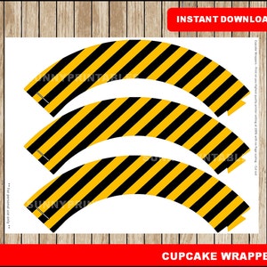 May include: Printable cupcake wrappers with a black and yellow striped pattern. The wrappers are designed to fit standard size cupcakes. The text "INSTANT DOWNLOAD" and "CUPCAKE WRAPPERS" is visible on the image.  The text "For personal use only" is also visible.