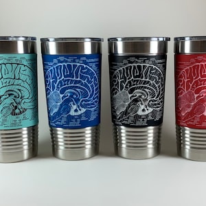 May include: Four stainless steel tumblers with a white anatomical brain design on the exterior. The tumblers are in four different colors: teal, blue, black, and red.