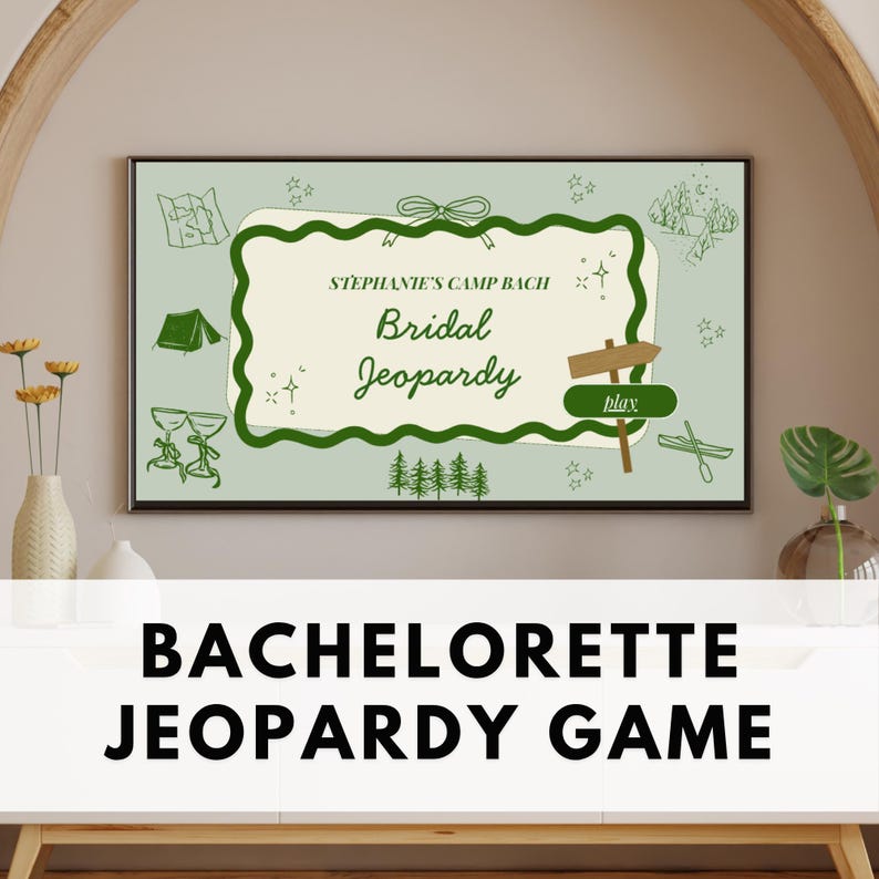 May include: A framed sign with the text "Stephanie's Camp Bach Bridal Jeopardy" in green and white. The sign has a light green background with camping-themed illustrations. The words "Bachelorette Jeopardy Game" are displayed below the framed sign.