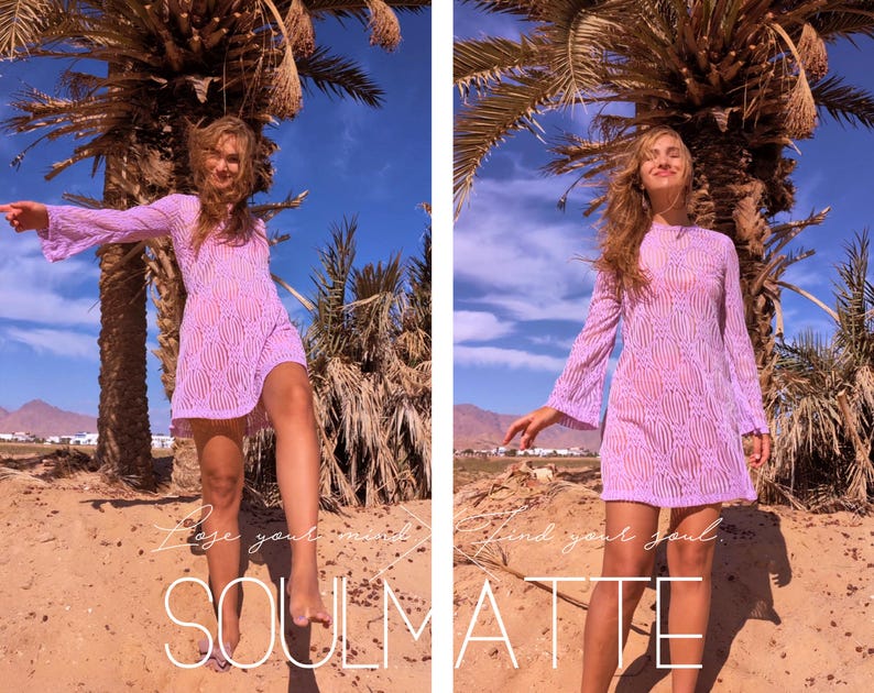 May include: A woman wearing a light purple, sheer, long-sleeved dress with a wavy pattern. She is standing on a sandy beach with palm trees in the background. The text "Lose your mind and find your soul. SOULMATE" is written on the sand.