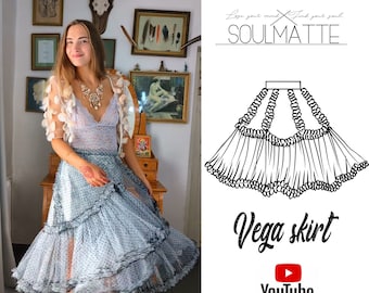 May include: A light blue midi skirt featuring a dotted pattern, tiered ruffled layers, and a high-waisted design. The image includes a black and white line drawing of the skirt labeled Vega skirt, along with the text SOULMATTE and YouTube.