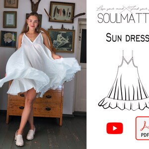 May include: A woman wearing a white sun dress with spaghetti straps and a V-neck. The dress has a flowing skirt and a ruffled hem. The image also includes the text "SOULMATTE" and "SUN DRESS".