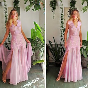 May include: A pink maxi dress with a lace bodice and a high slit. The dress has a fitted bodice and a flowing skirt.