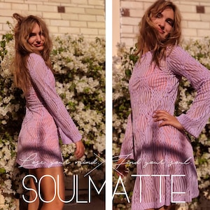 May include: A woman wearing a lavender sheer dress with a geometric pattern. The dress has long sleeves and a loose fit. The woman is standing in front of a wall of pink flowers.