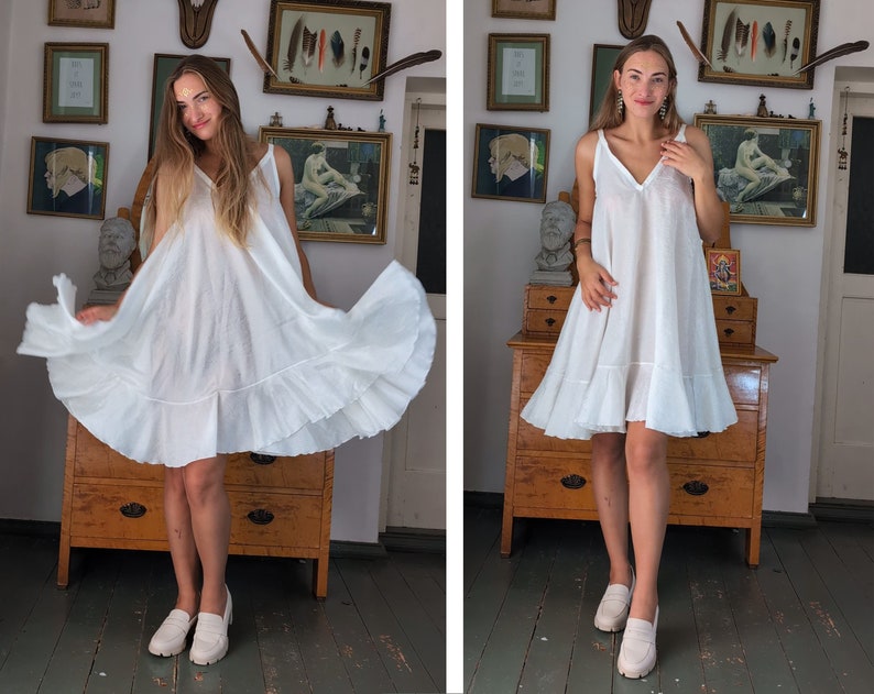 May include: Two images of a white, V-neck dress with spaghetti straps and a ruffled hem. The dress is knee-length and appears to be made of a lightweight fabric. The person in the image is wearing white loafers.
