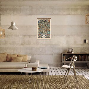 May include: A vintage map print of a city with a detailed illustration of buildings and streets. The map is framed and hanging on a wall in a modern living room with a beige couch, a coffee table, and a chair.