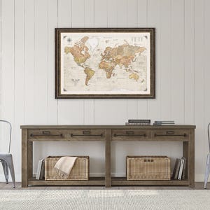 a wooden console table with two metal chairs, a framed world map hanging on the wall above the table, and two wicker baskets on the floor.