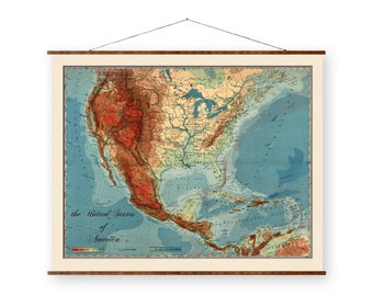 May include: A vintage map of the United States of America, showing the topography of the country with different colors. The map is printed on a canvas and is framed with a wooden frame. The map is hung on a wall with a string.