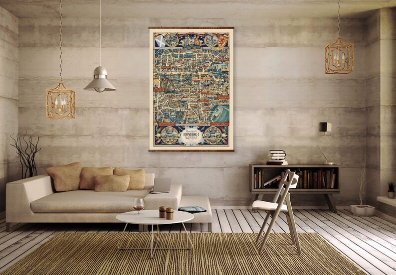 May include: A vintage map of Edinburgh, Scotland, printed on canvas and framed in a wooden frame. The map is displayed on a wall in a living room setting with a couch, coffee table, and chair.