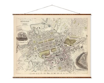 May include: A vintage map of Edinburgh, Scotland, printed in black and white with hand-drawn details. The map shows the city's streets, parks, and landmarks, including Edinburgh Castle. The map is framed with a wooden border.