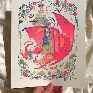May include: A whimsical illustration depicting a woman riding a red dragon with a castle in the background. The woman is wearing a green dress and a pointed hat. The dragon has wings and a long tail. The castle is white with a red roof. The illustration is surrounded by a border of vines and flowers.