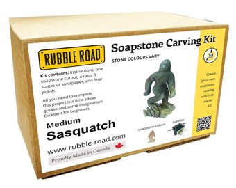 May include: A cardboard box labeled "Soapstone Carving Kit" from Rubble Road. The kit includes a soapstone cutout, rasp, sandpaper, and polish. The box features a Sasquatch carving and the text "Medium Sasquatch".