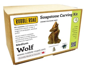 May include: A soapstone carving kit in a cardboard box. The kit includes a soapstone cutout, sandpaper, rasp, and polish. The box features the text "Soapstone Carving Kit" and "Wolf". The kit is designed for beginners.