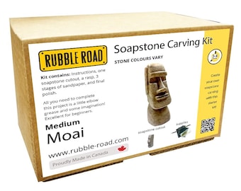 May include: A cardboard box labeled "Soapstone Carving Kit" from Rubble Road. The kit includes a soapstone cutout, sandpaper, rasp, and polish. The box features a Moai carving and the text "STONE COLOURS VARY".