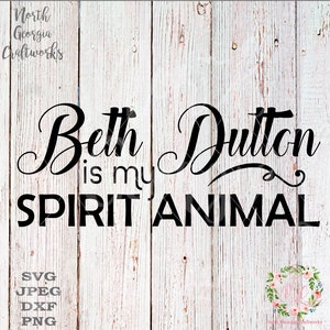 May include: A digital graphic design featuring the black text Beth Dutton is my SPIRIT ANIMAL in a mix of cursive and block fonts. The text is overlaid on a white vertical wood plank background. The North Georgia Craftworks logo is visible.